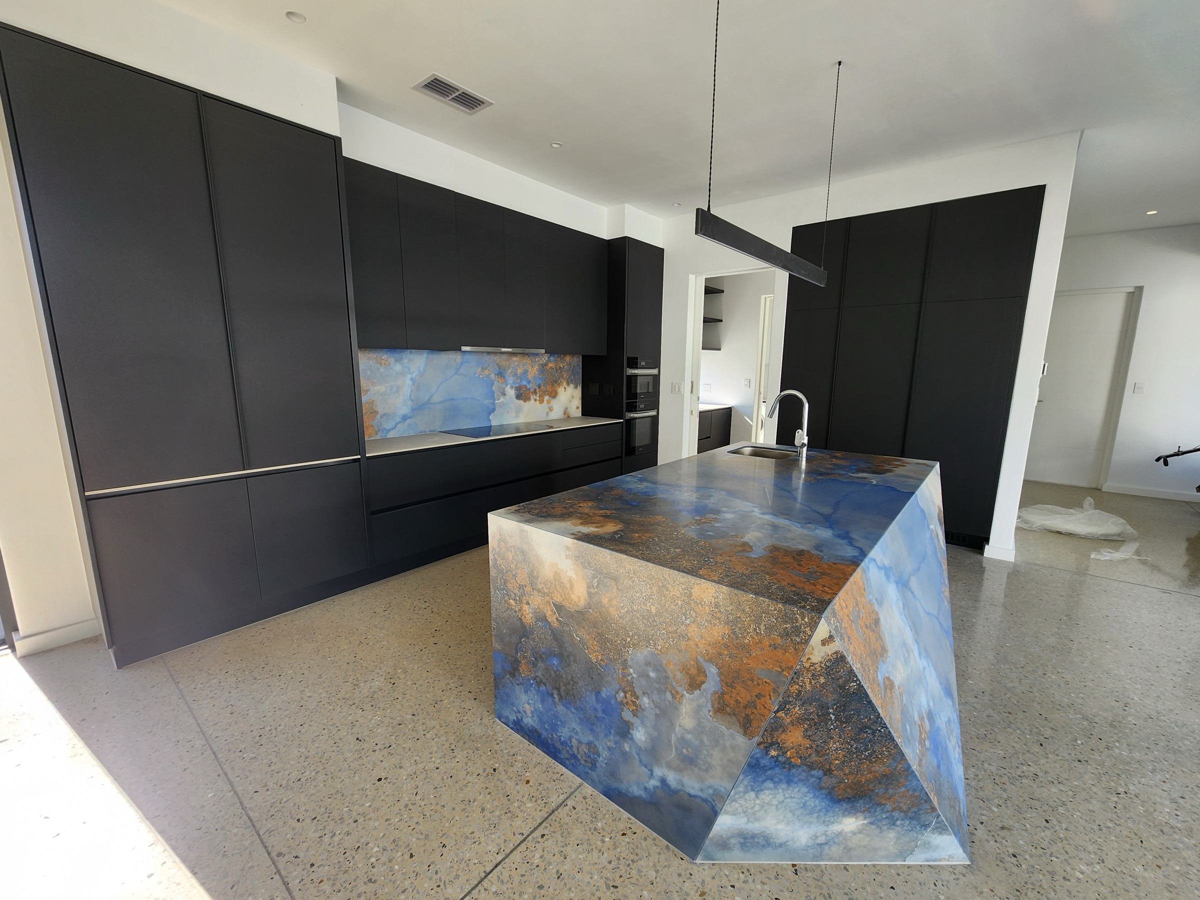 Sculpted porcelain kitchen island by Lunar Granite